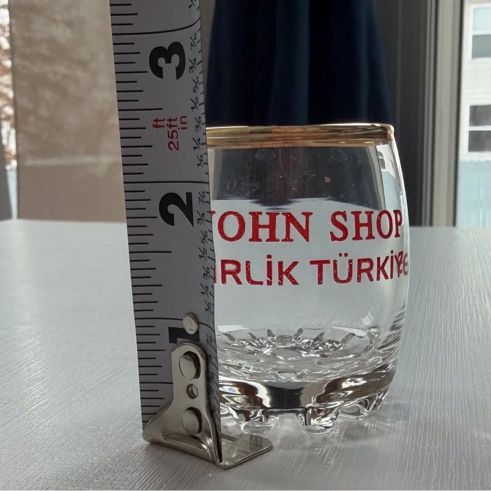VTG I John Shop in‎ Incirlik, Türkiye shot glass in a gold rim & bold red text